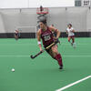 Temple field hockey player moving the ball up the field. 