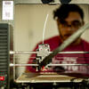 An engineering student works in a lab on campus.