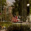 Temple campus stock photo with bicyclist riding through trees and food trucks on the street
